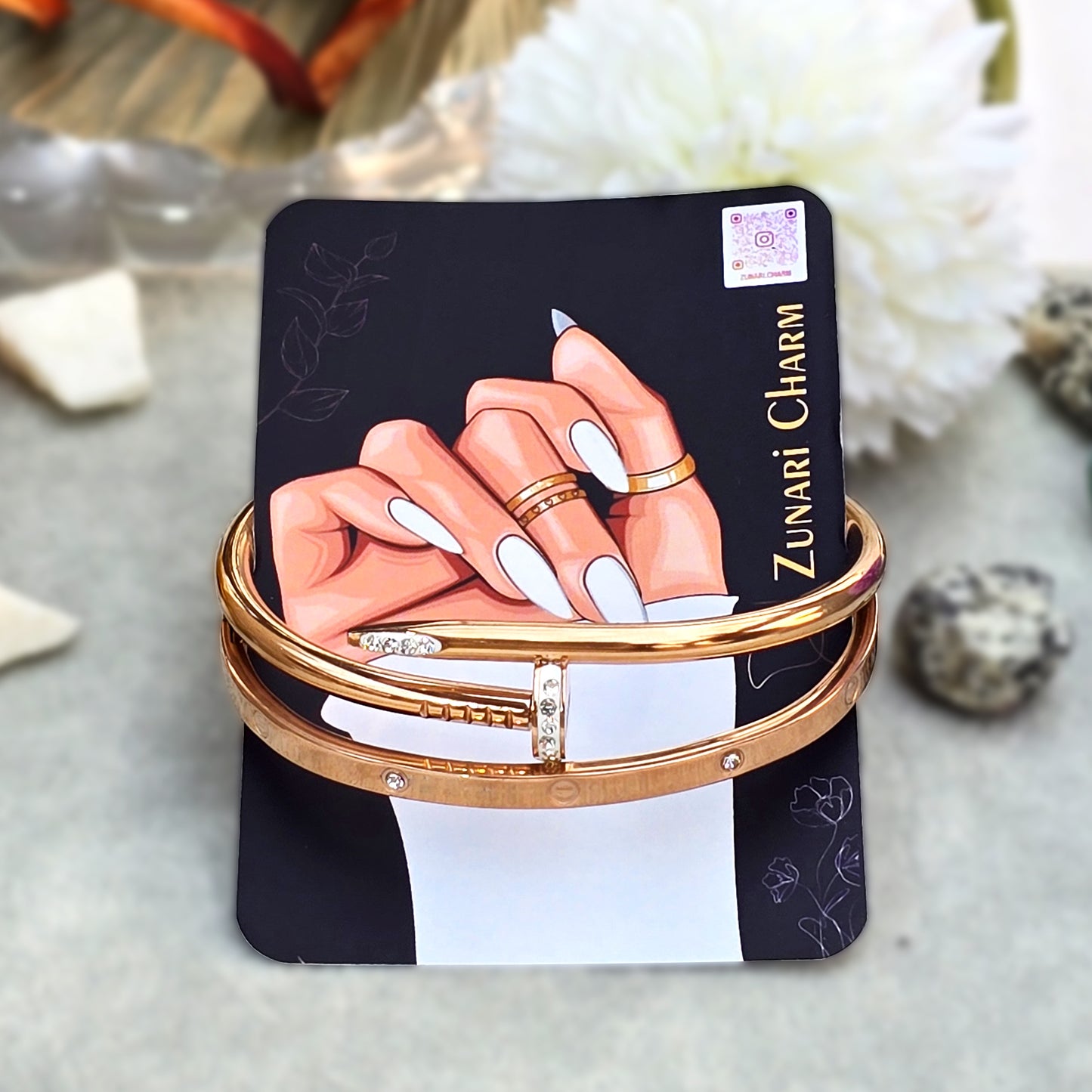Gold nail and screw bangle set displayed together on Zunari Charm branded packaging card.