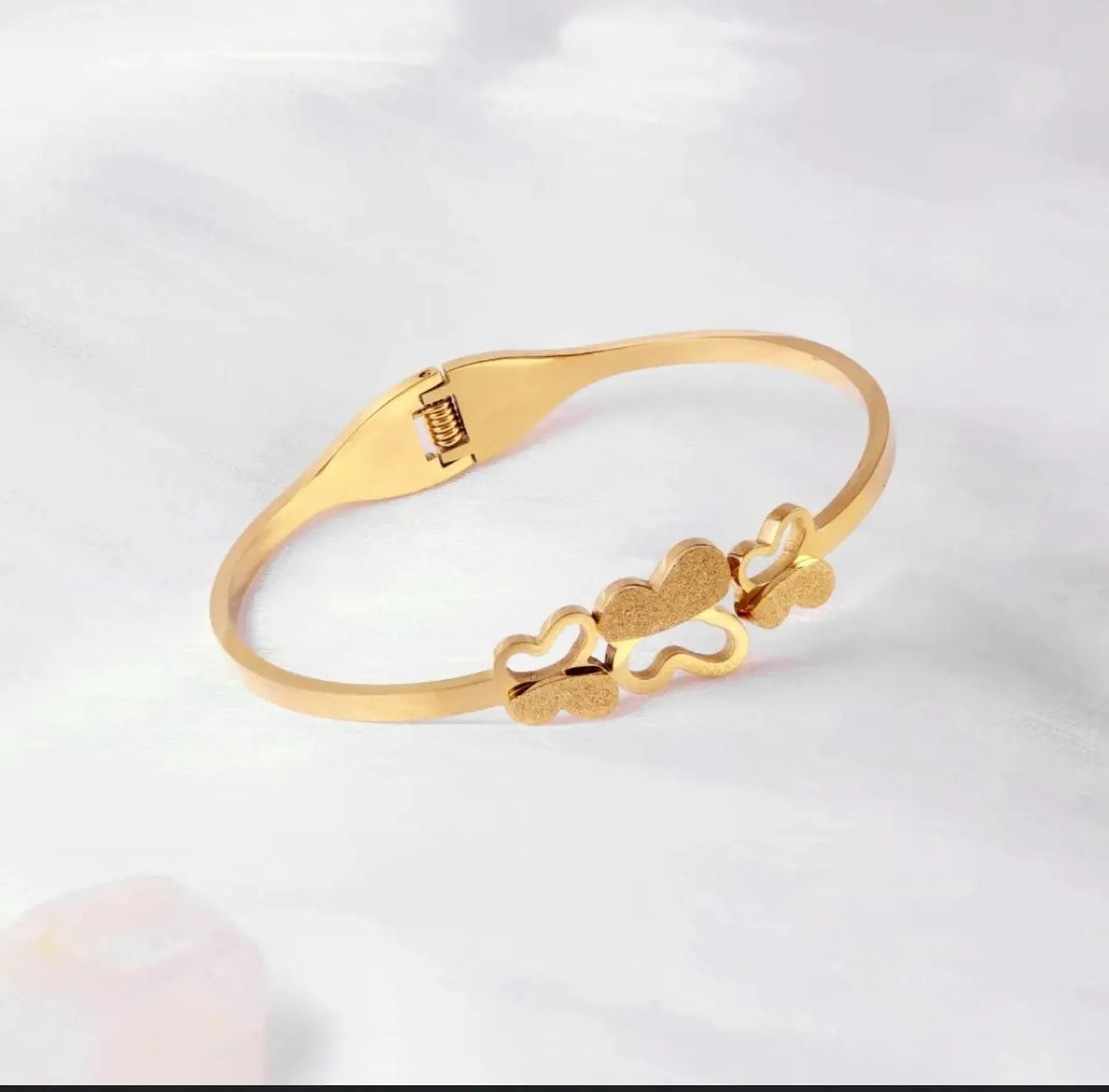 Triple Butterfly gold bracelet on white background – clasp visible