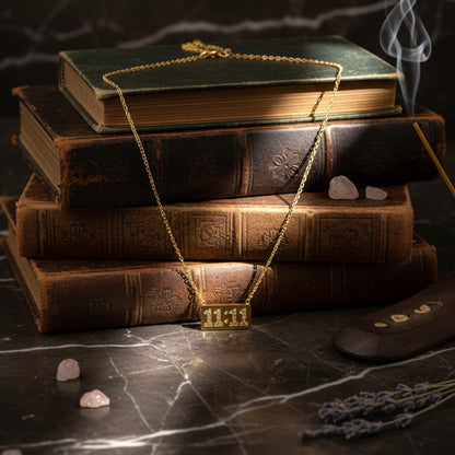 11:11 Necklace placed on vintage books and marble background with soft lighting.