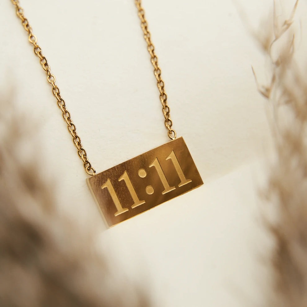 Minimalist 11:11 necklace photographed in warm natural lighting