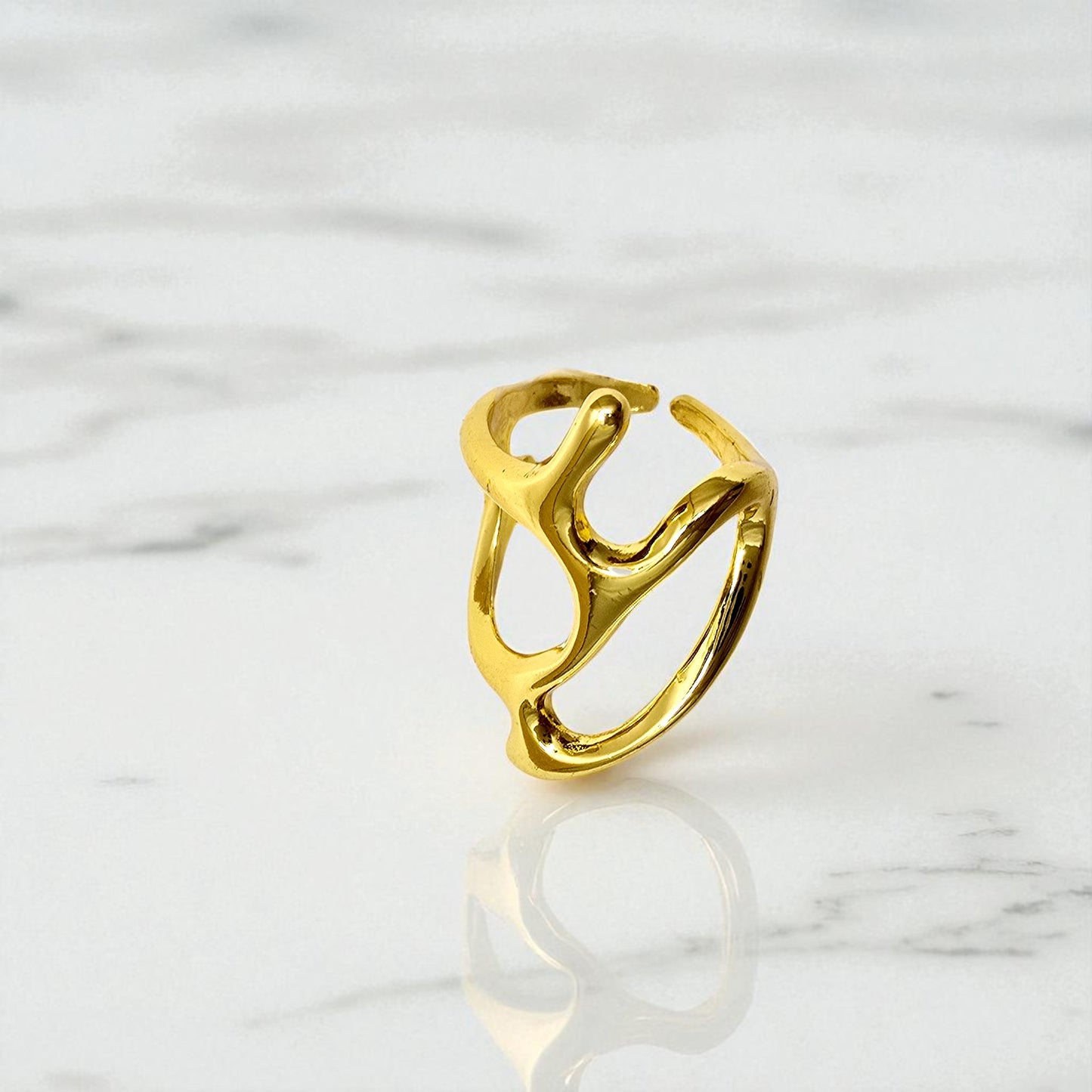 Close-up of Abstract Frame Ring displayed on a marble background