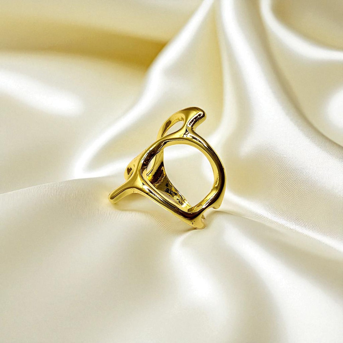 Abstract Frame Ring placed on satin fabric for luxury product photography