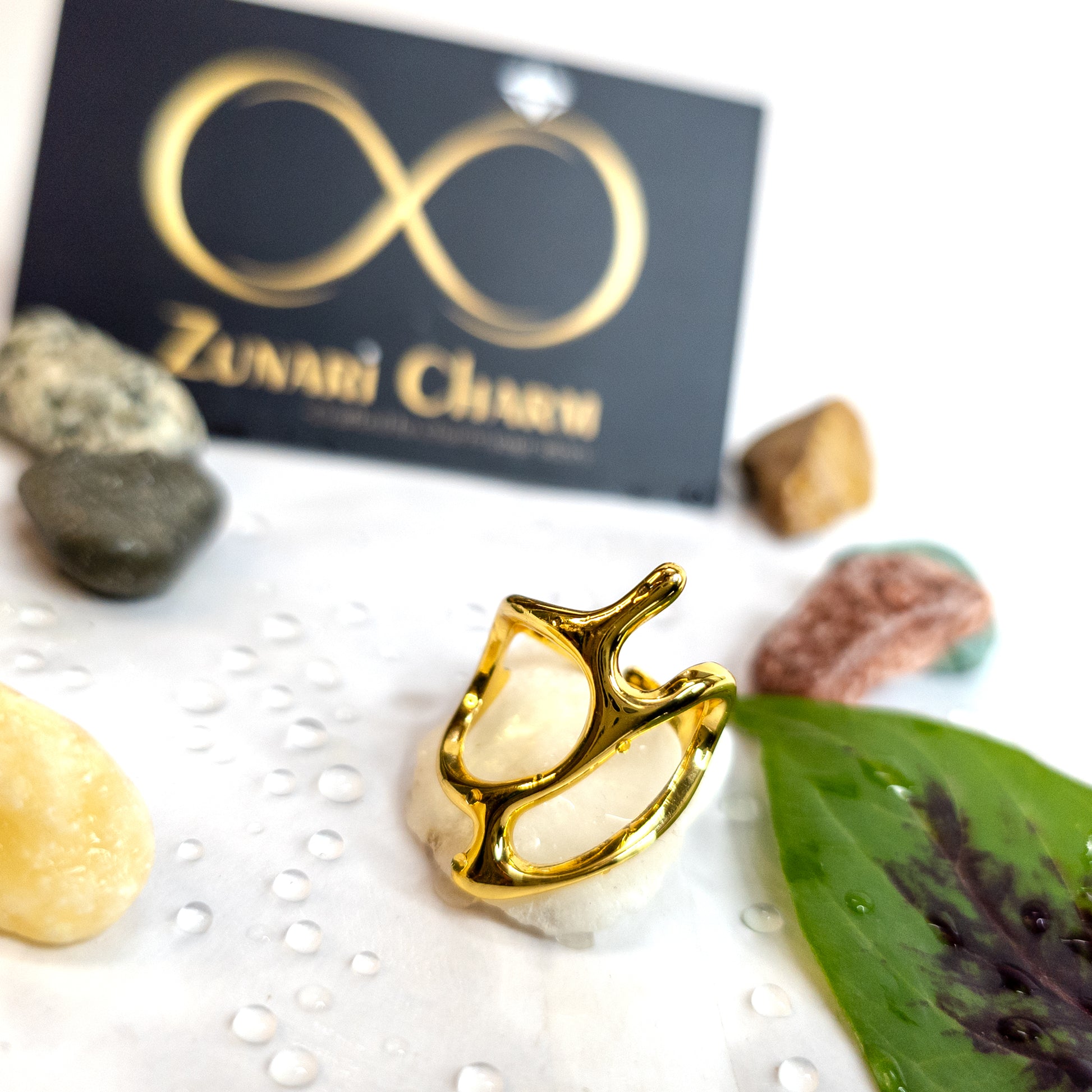 Abstract Frame Ring photographed with Zunari Charm packaging in background.