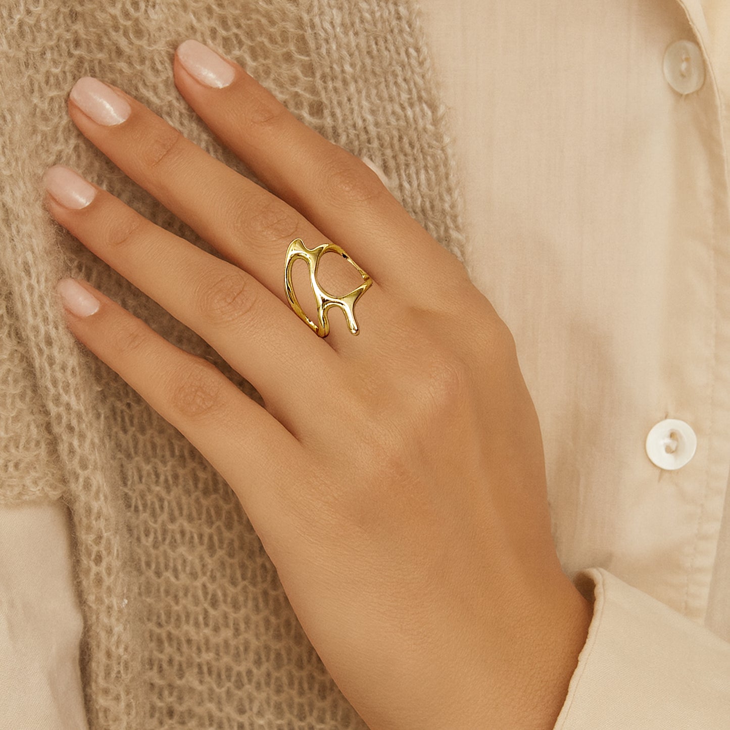 Model wearing Abstract Frame Ring in gold with modern open-frame design.
