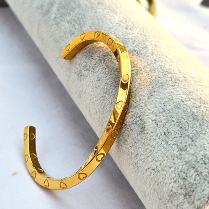 Side view of Amour Twist Cuff showing the mobius curve and heart detailing.