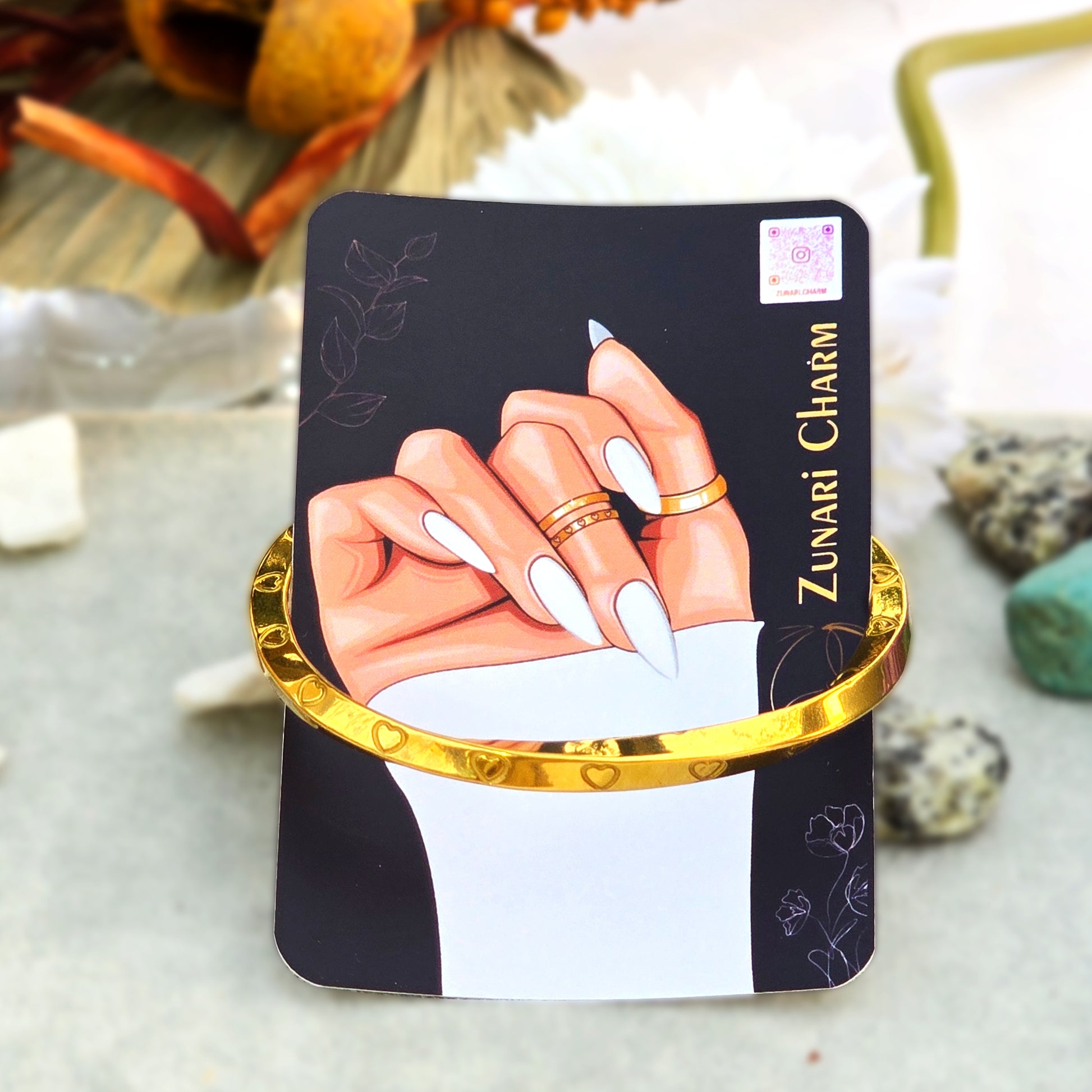 Amour Twist anti-tarnish gold cuff displayed on Zunari Charm branded packaging card.