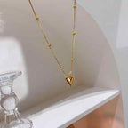 Pendant necklace hanging elegantly from a shelf with glass décor