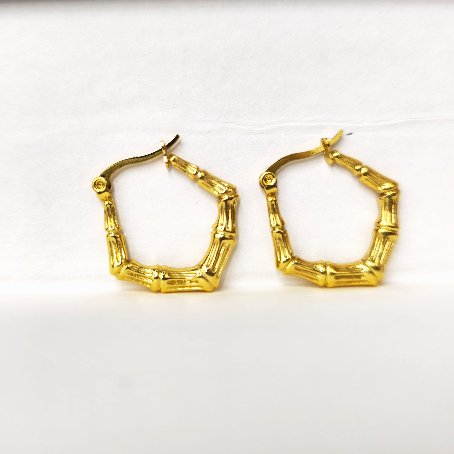 Bamboo Luxe Earrings – textured gold bamboo-inspired hoops on display