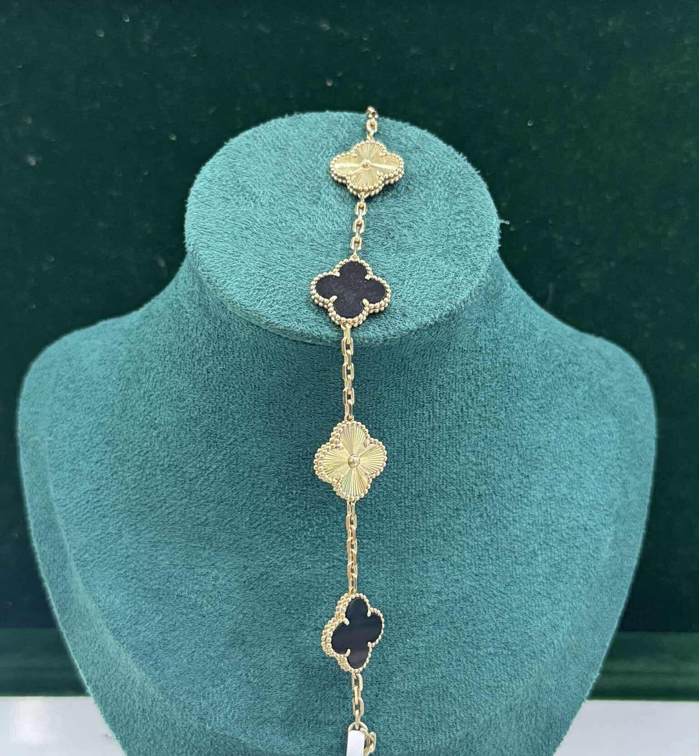 Anti Tarnih Lucky Black Clover Bracelet on a green background