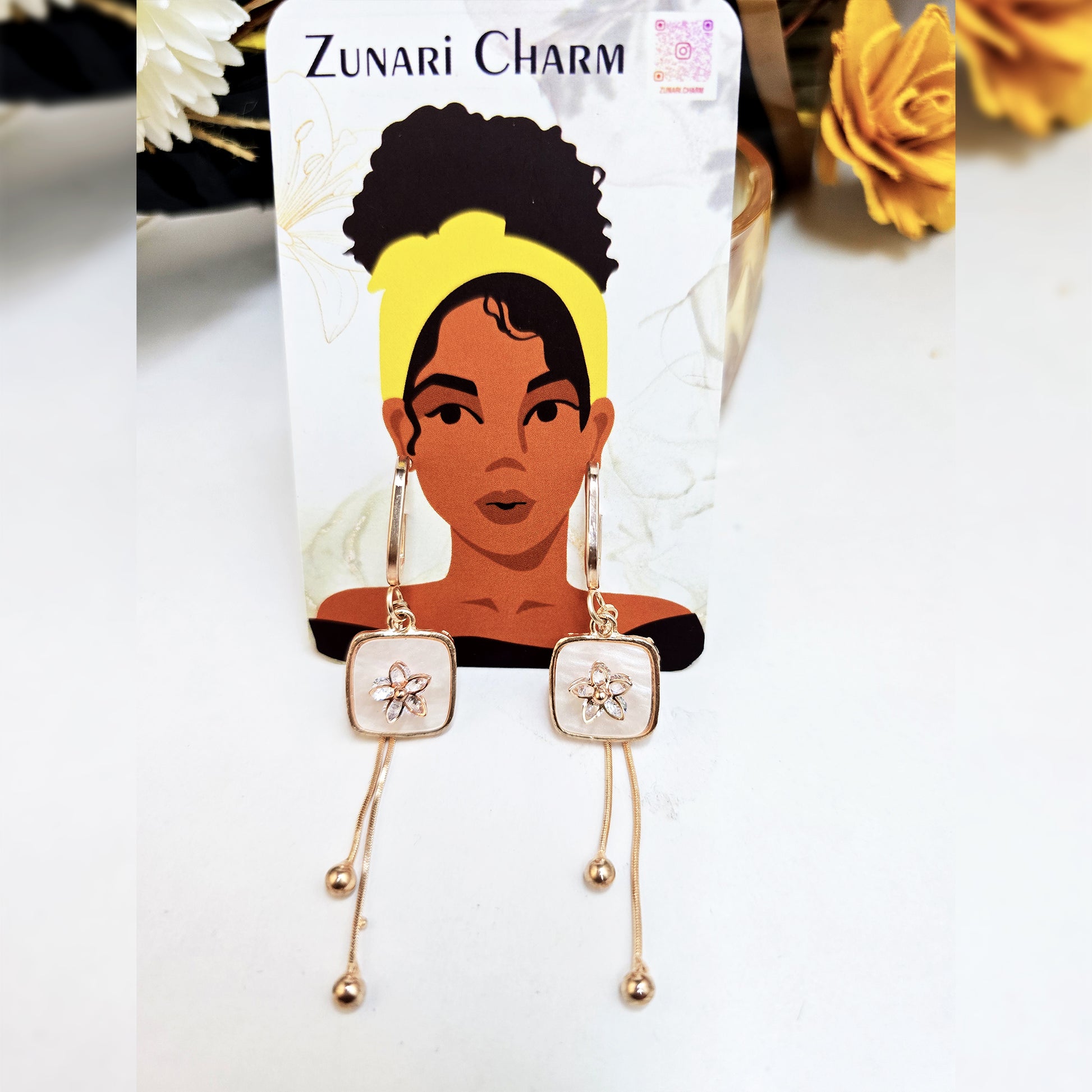 Blush Drop floral earrings displayed on a Zunari Charm branded card with the signature yellow-turban illustration.