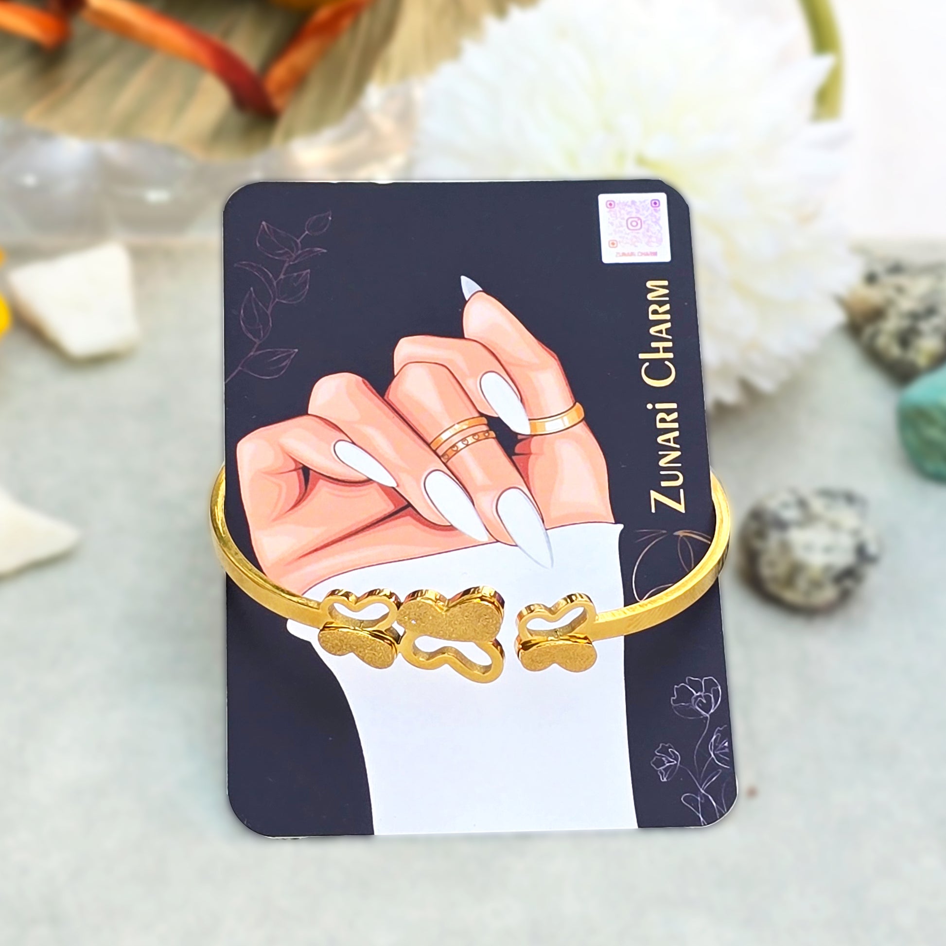 Butterfly Trinity Bangle displayed on Zunari Charm branded packaging card.