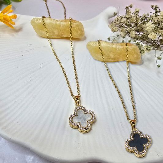 Gold-plated four-leaf clover pendant necklace showing the solid gold side.