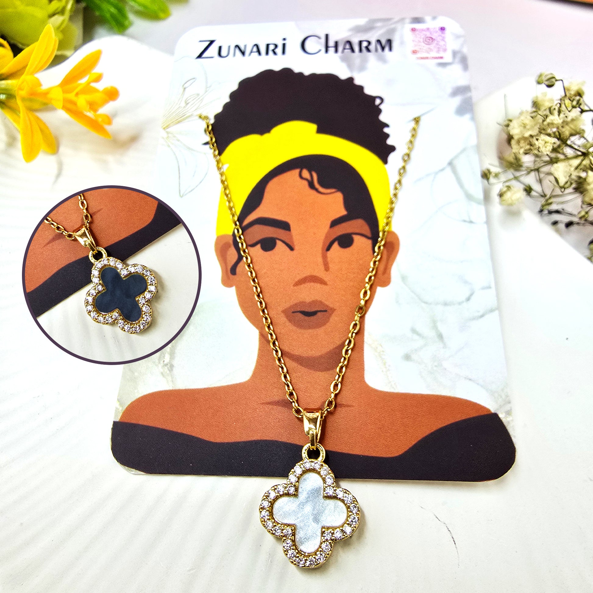 Zunari Charm reversible good luck clover pendant displayed on a branded jewelry card.