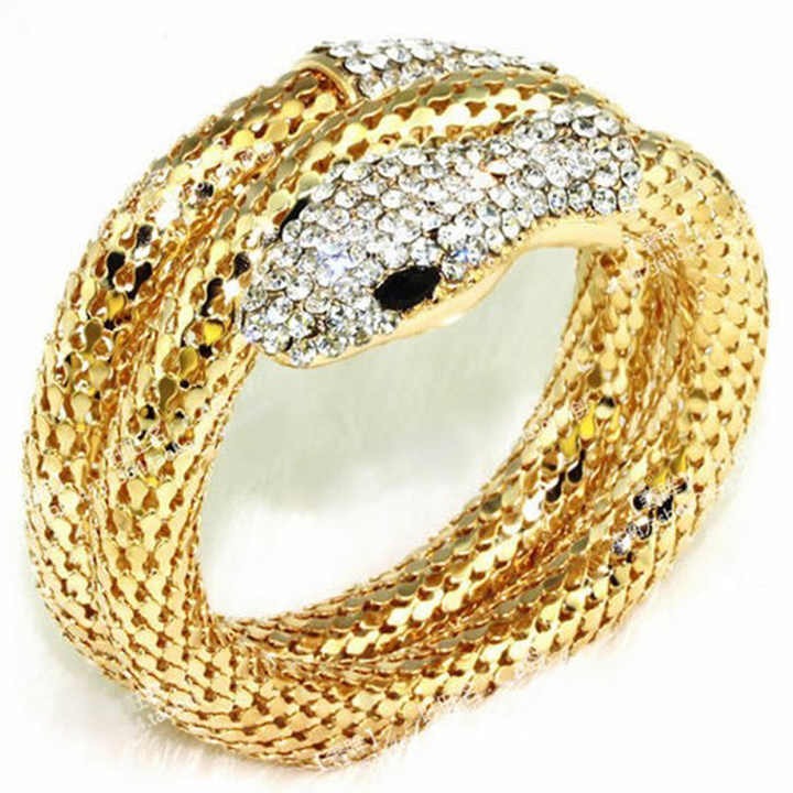 Coiled snake cuff bracelet with crystal face and scales – detailed macro shot