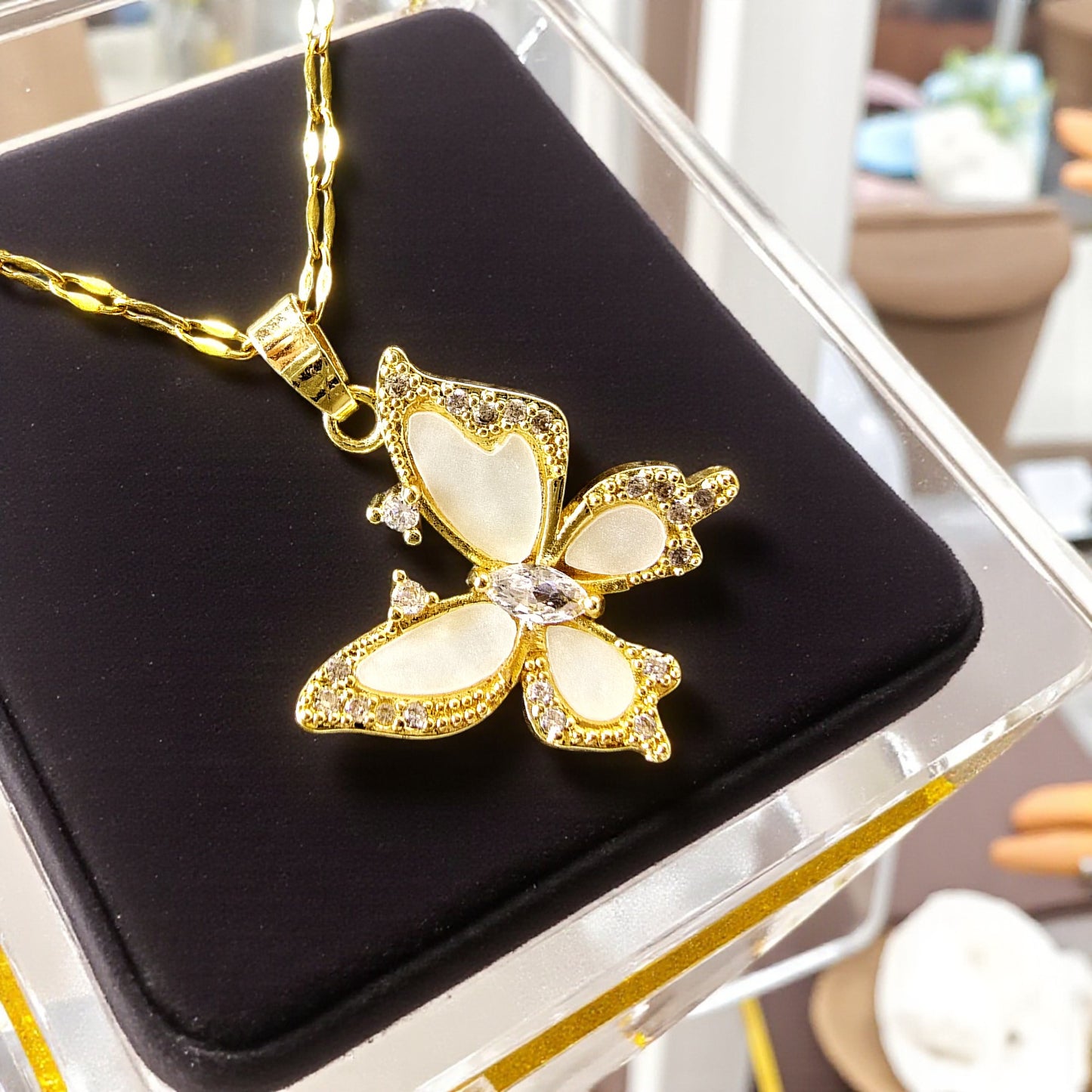 Crystal Butterfly Pendant displayed on black velvet – gold and crystal jewelry close-up