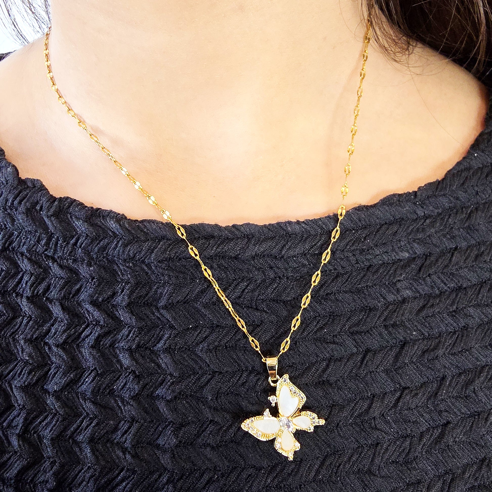Model wearing Crystal Butterfly Pendant Chain – gold necklace with crystal butterfly pendant