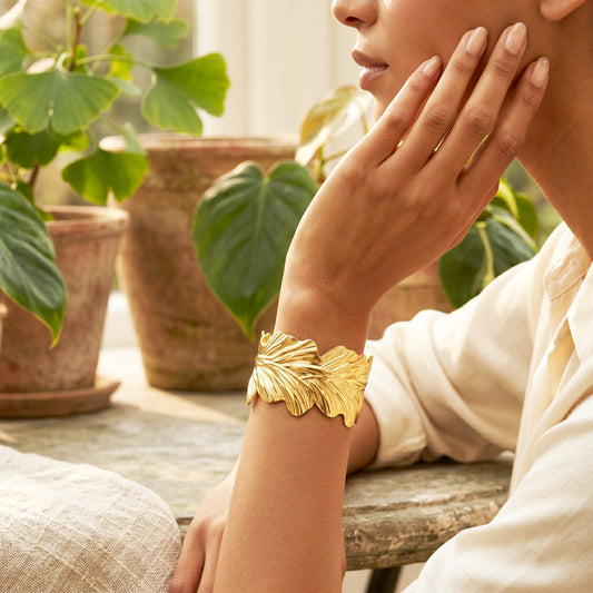 Woman wearing Eden gold cuff bracelet elegant styling
