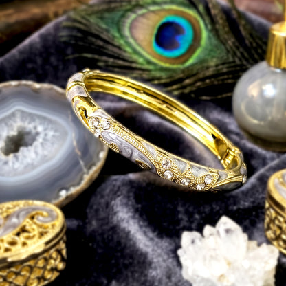 Luxury ash bracelet with crystal stones styled on velvet tray