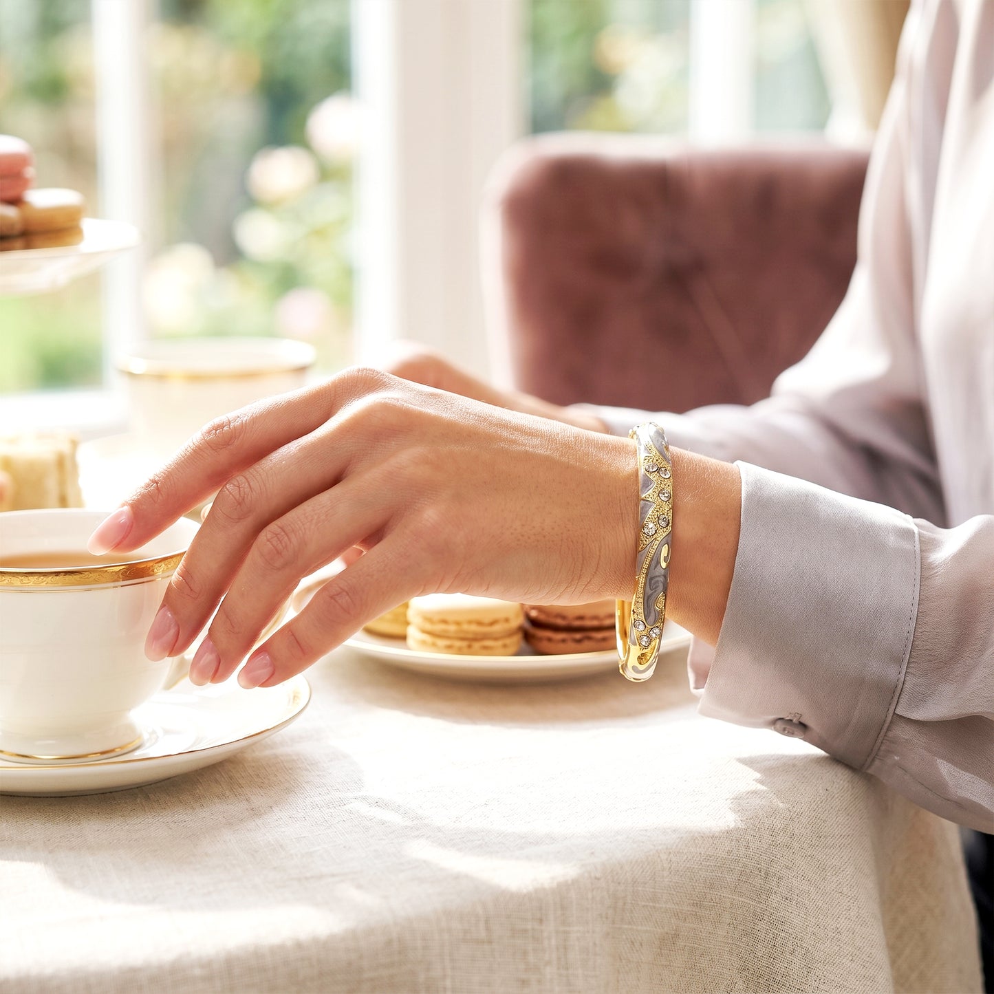 Woman wearing ash crystal bracelet while having tea