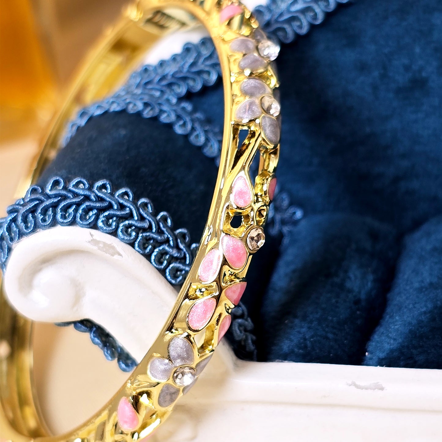 Pink enamel floral crystal bangle bracelet close-up view