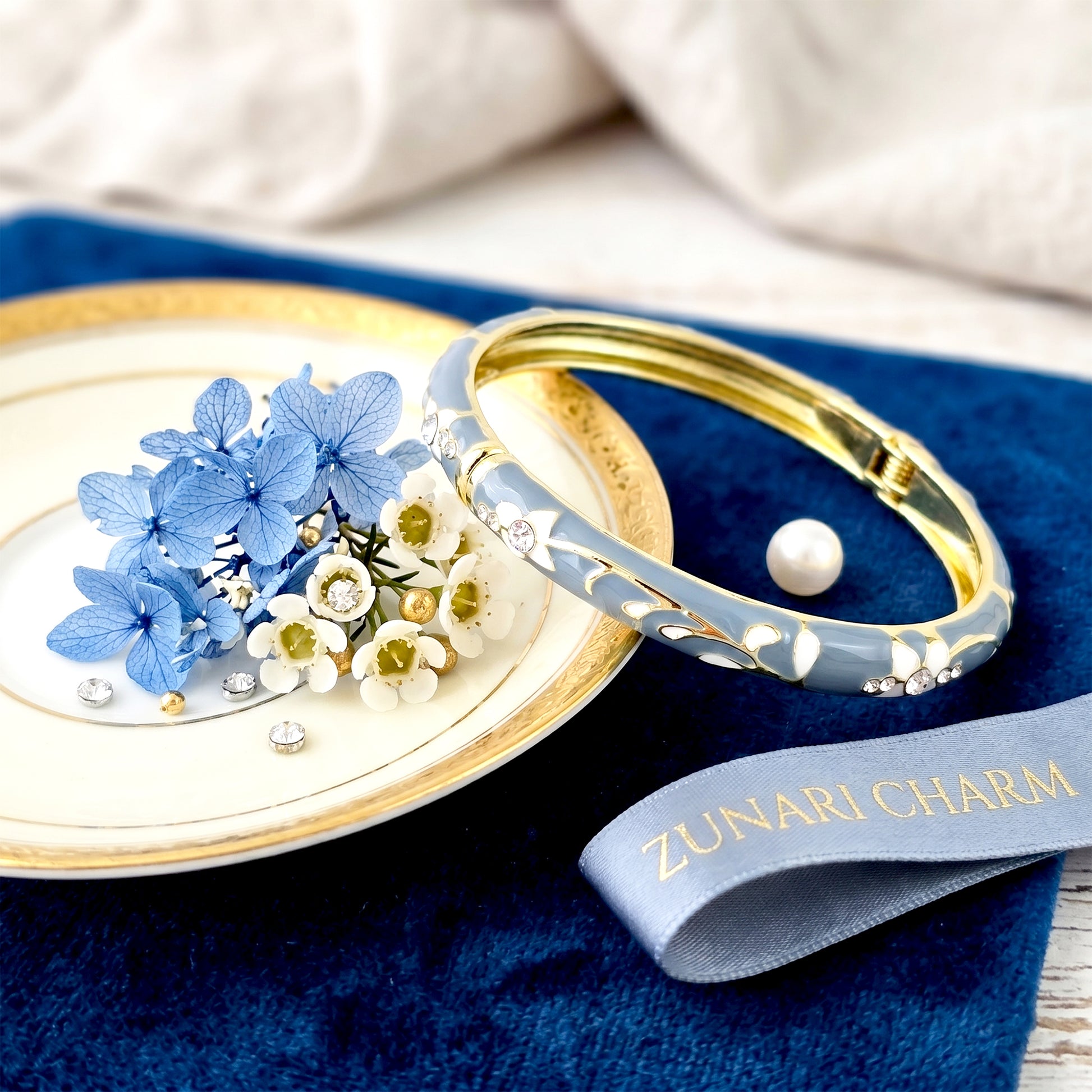 Gold teal bangle with flowers styled with plate and flowers