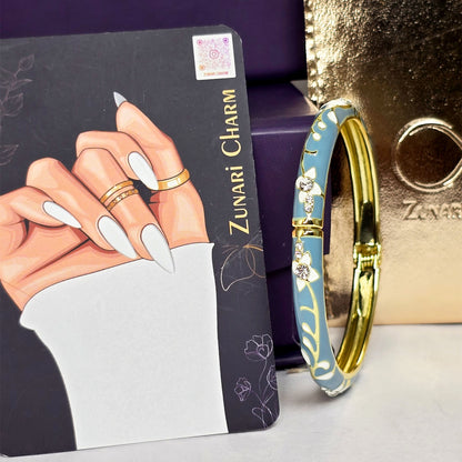 Zunari Charm teal enamel bracelet display card close-up