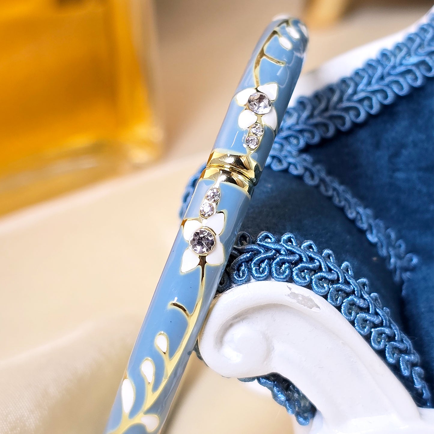 Close-up of teal crystal floral bracelet on velvet display