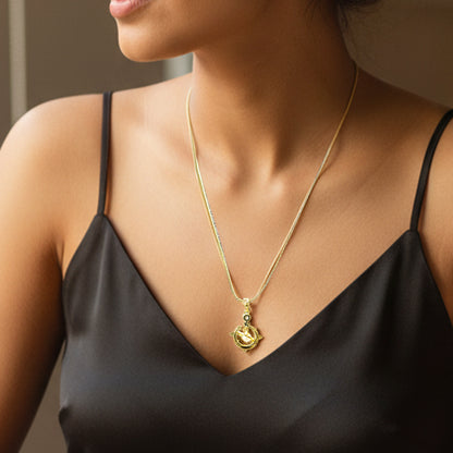 Model wearing Galaxy Charm Pendant Chain – elegant gold necklace paired with black satin dress.