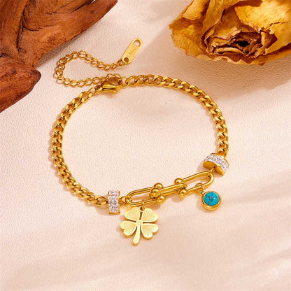  Elegant women’s charm bracelet with four-leaf clover and blue evil eye