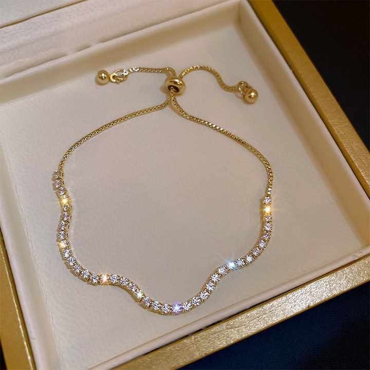 Gold bracelet with crystals on a gold box