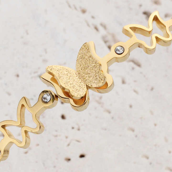 Close-up of the textured butterfly design with embedded crystals