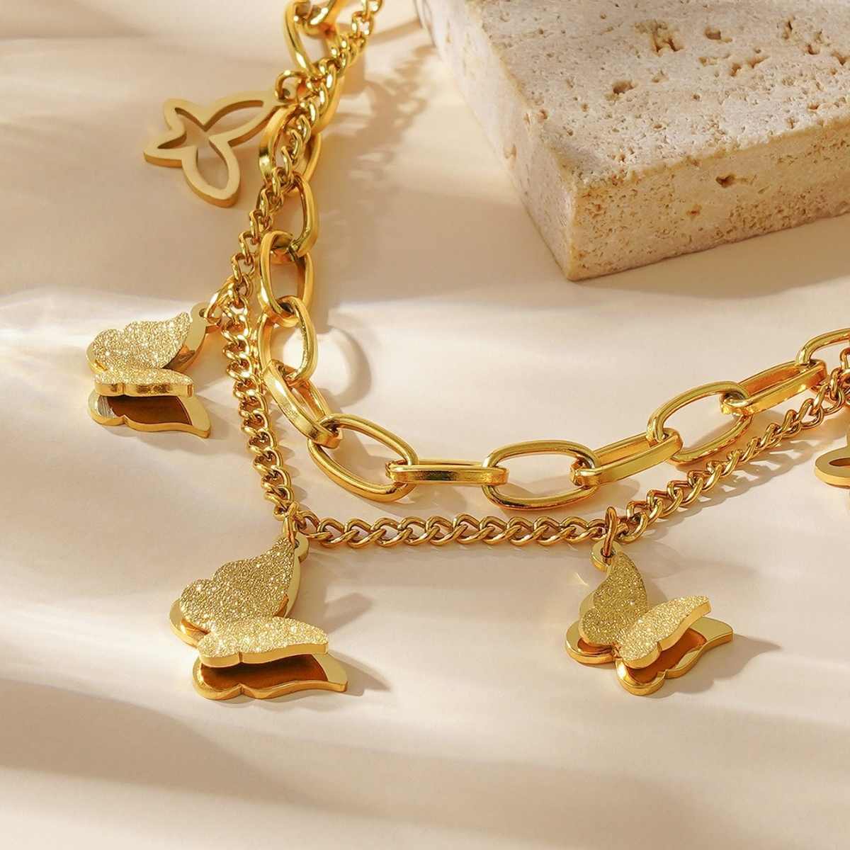 Close-up of butterfly charms and chain links