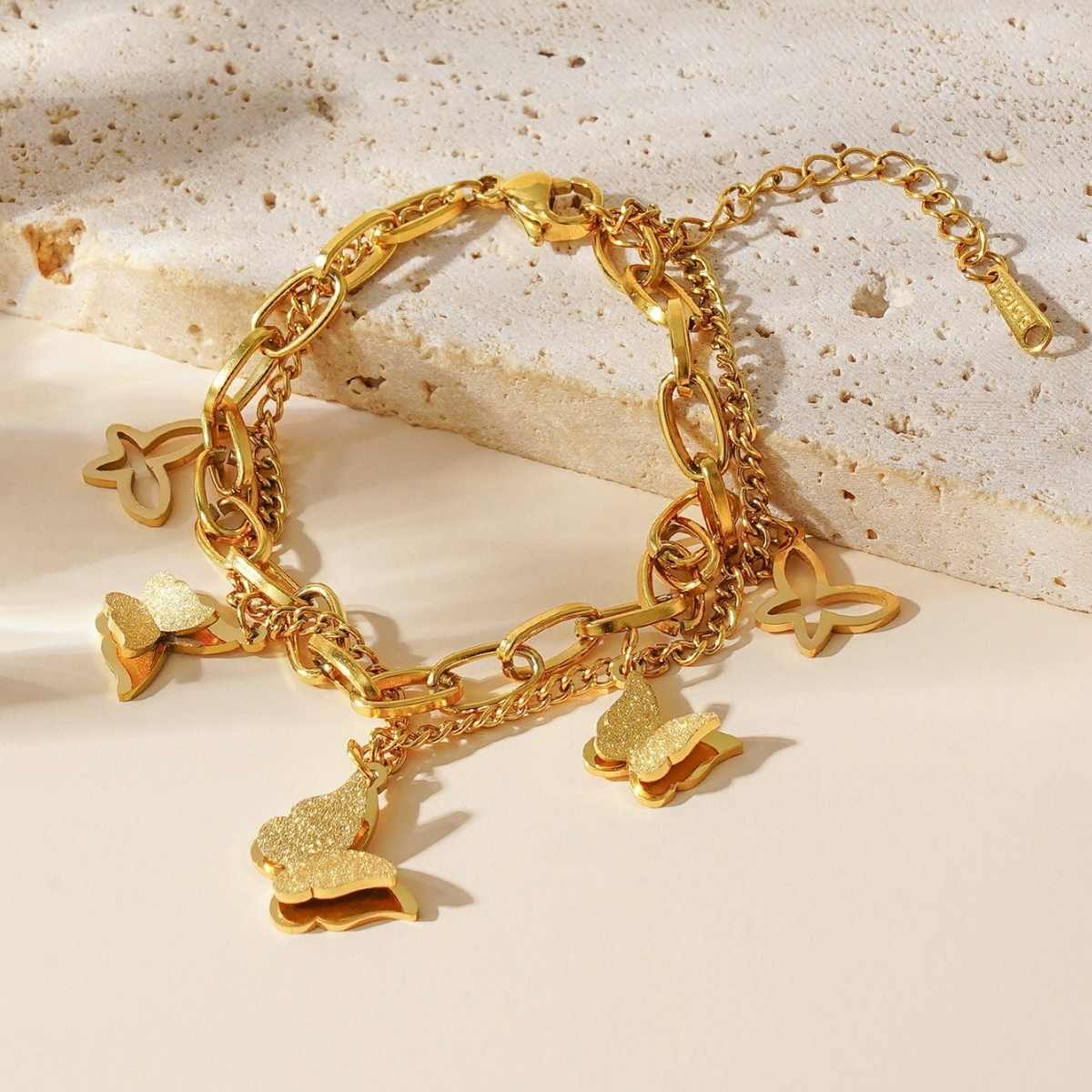 Bracelet placed on a beige stone slab under soft sunlight
