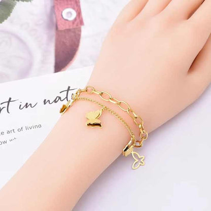 Butterfly charm bracelet worn on a woman’s wrist – close-up