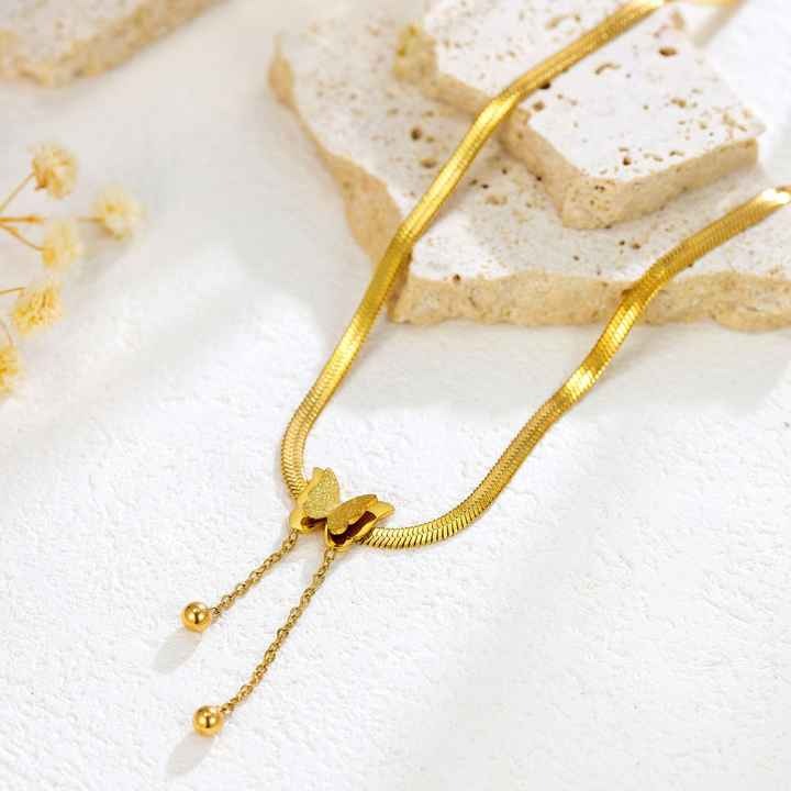 Modern butterfly charm necklace flatlay