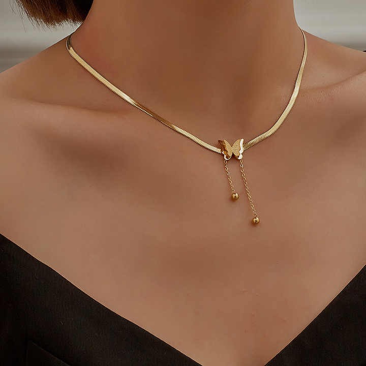 Chic gold snake chain necklace styled with black outfit