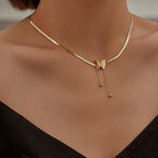Chic gold snake chain necklace styled with black outfit