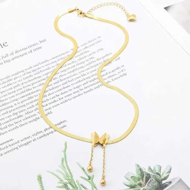 Waterproof butterfly chain necklace on white textured backdrop