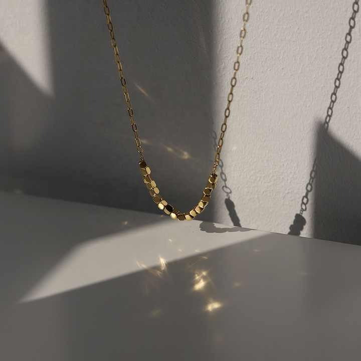 Close-up of Pixel Necklace catching light and shadow reflections