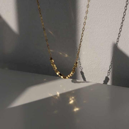 Close-up of Pixel Necklace catching light and shadow reflections