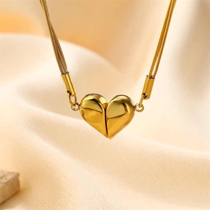 Zoomed view of gold heart pendant with magnetic design on satin