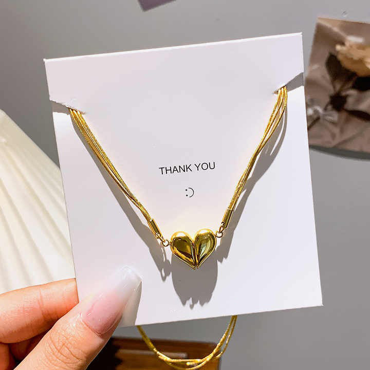 Magnetic heart necklace displayed on thank-you card packaging