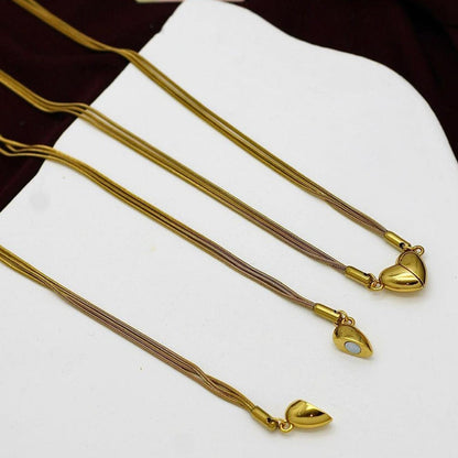 2 magnetic heart necklaces displayed on flatlay with white base. One shows open necklace and other shows closed necklace