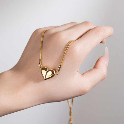 Magnetic heart necklace on hand showing split heart design