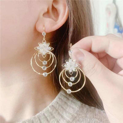 Model showcasing lotus earrings with tassel drops, side profile