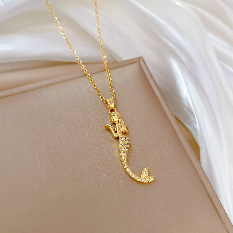 Close-up of gold mermaid necklace with sparkly tail