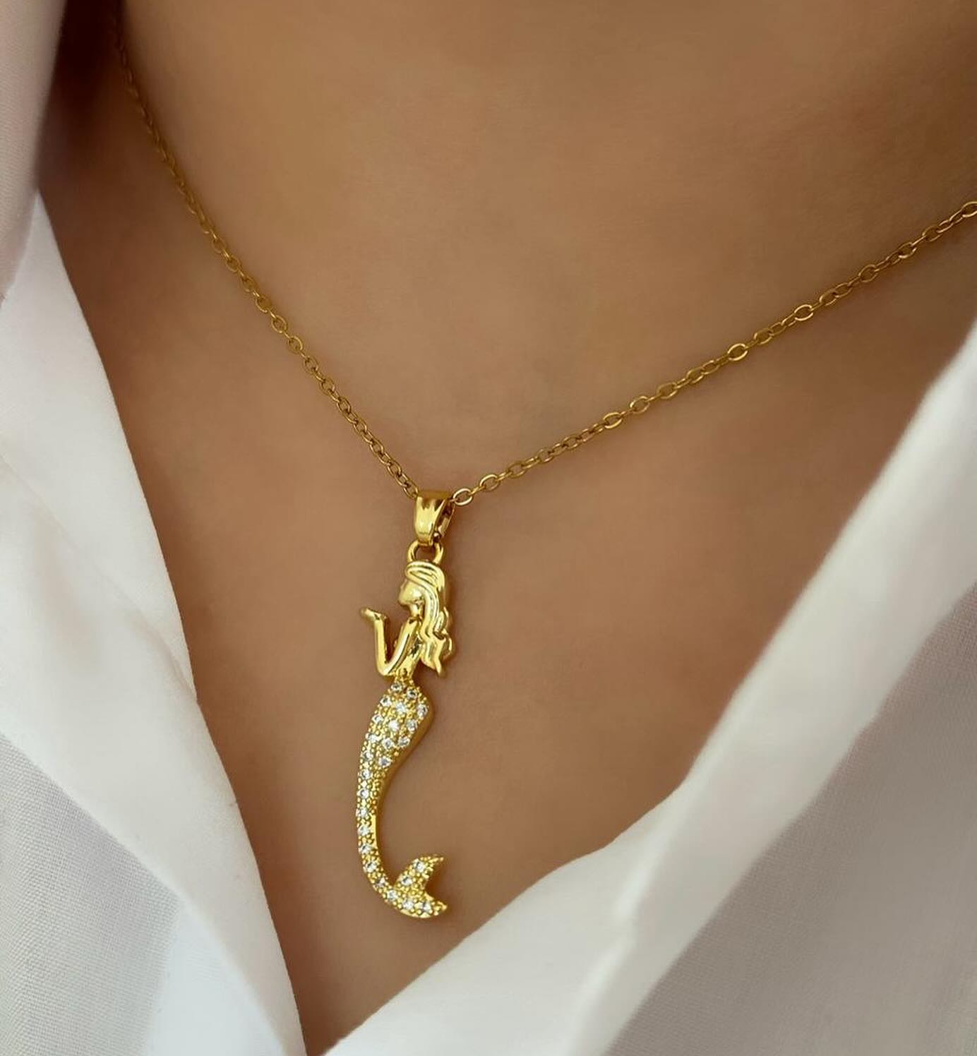 Mermaid pendant worn on model with white shirt