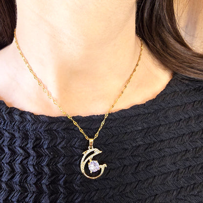 Model wearing Dolphin Pendant Chain – elegant gold necklace with crystal centerpiece.