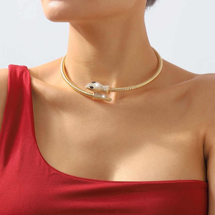 Closeup of model in red top wearing gold serpent choker – bold and elegant aesthetic.