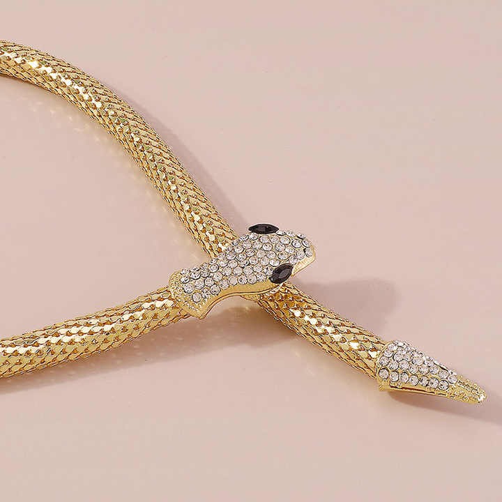 Adjustable snake necklace laid flat, showcasing detailed texture and encrusted design.